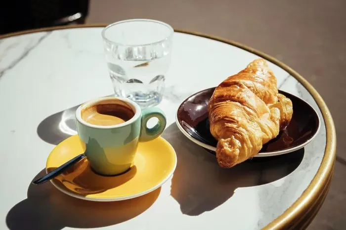 Framed Print : France, Paris, Croissant, coffee and glass of water on sidewalk cafe table