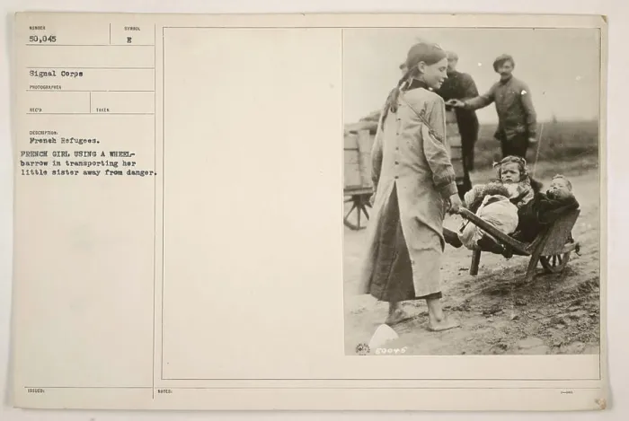 Framed Print : French girl using a wheelbarrow to transport her little sister away from danger during World War One