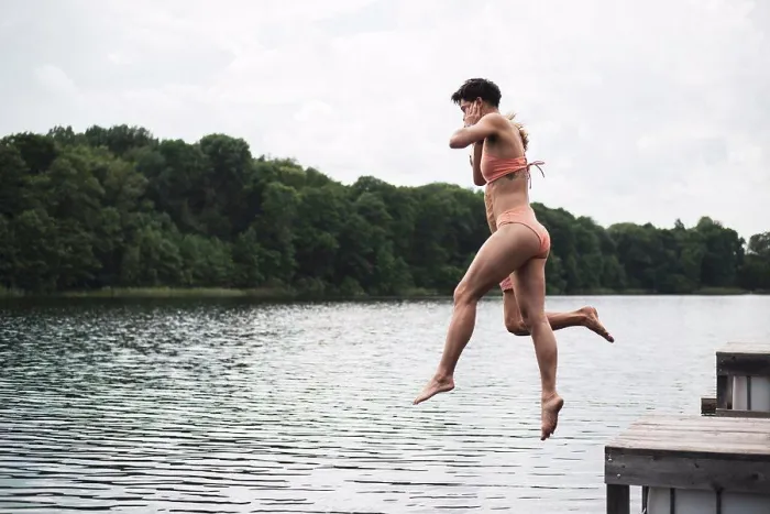 Framed Print : Friends jumping in lake in Poland in orange swimsuit in summer Framed Print : Friends jumping in lake in Poland in orange swimsuit in summer