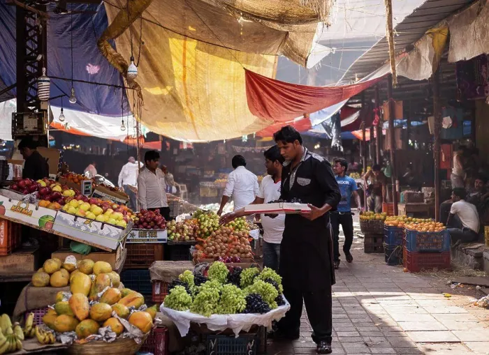Framed Print : Fruit Vendor stocking fruit supply at outdoor Mumbai Market Framed Print : Fruit Vendor stocking fruit supply at outdoor Mumbai Market