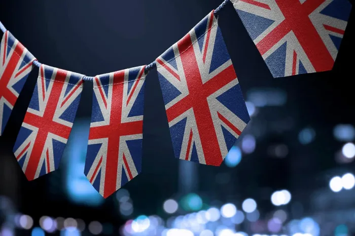 Framed Print : A garland of United Kingdom national flags on an abstract blurred background A garland of United Kingdom national flags