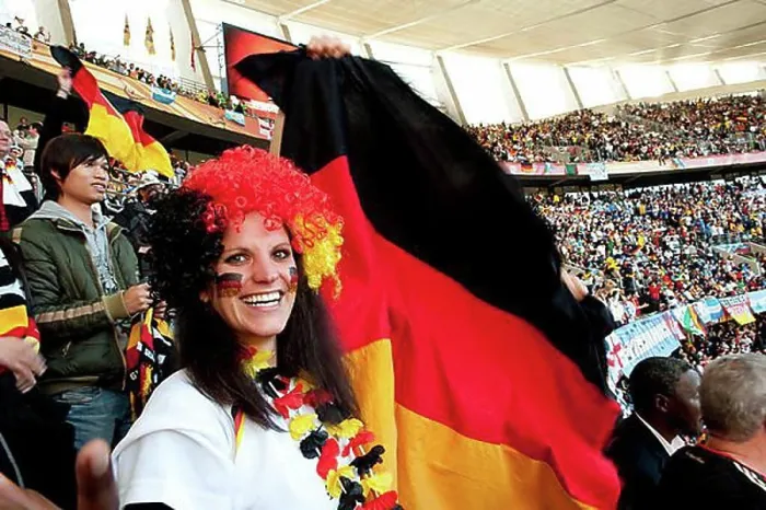 Framed Print : German football supporter with the German national flag in the stadium Framed Print : German football supporter with the German national flag in the stadium