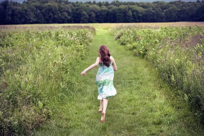 Framed Print : A girl running through a meadow in summer Framed Print : A girl running through a meadow in summer