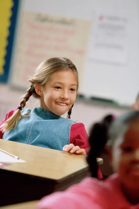Framed Print : Girl smiling in a classroom Framed Print : Girl smiling in a classroom