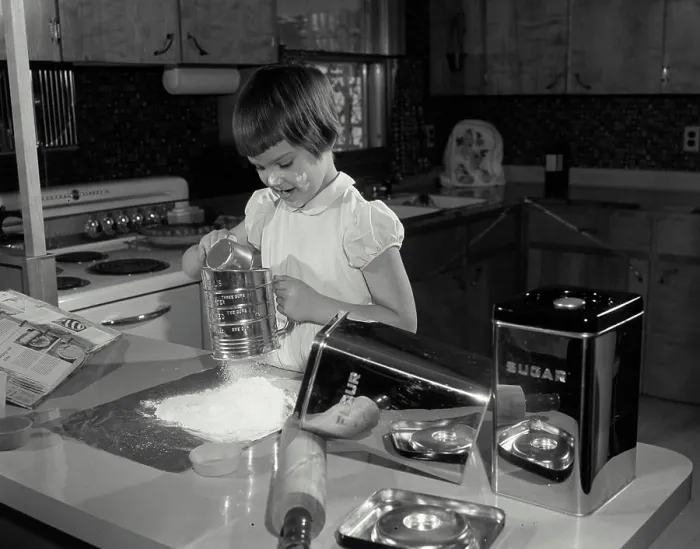 Framed Print : Girl working in a kitchen