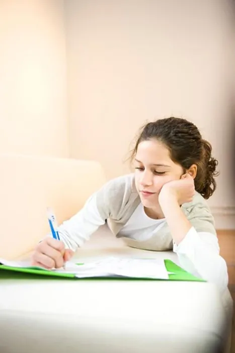 Framed Print : Girl writing on sheet of paper Framed Print : Girl writing on sheet of paper