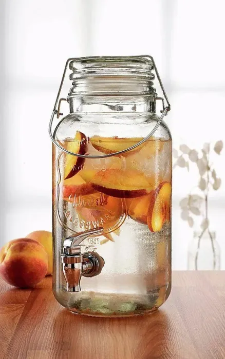 Framed Print : Glass jar with tap dispenser containing fresh peach drink Framed Print : Glass jar with tap dispenser containing fresh peach drink