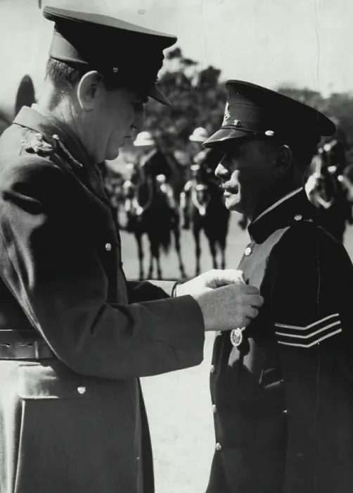 Framed Print : The governor lord Wakehard pinning king's police medal on breast of Sgt Tracker Alexander Relay