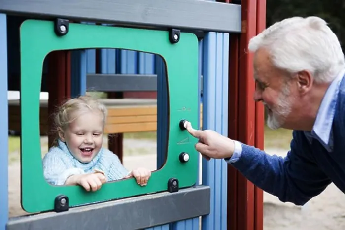 Framed Print : Grandfather and grandchild playing together on a playground, Sweden Framed Print : Grandfather and grandchild playing together on a playground, Sweden