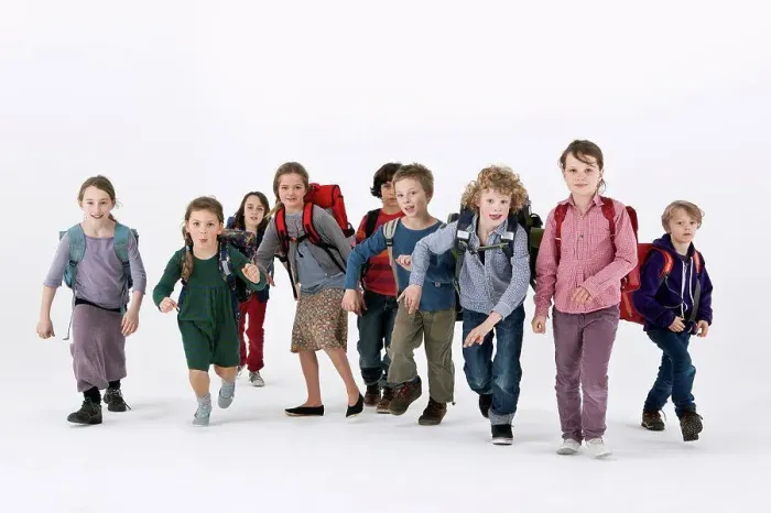 Framed Print : A group of school kids wearing backpacks and running forward Framed Print : A group of school kids wearing backpacks and running forward