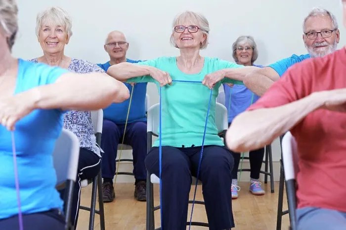 Framed Print : Group Of Seniors Using Resistance Bands In Fitness Class