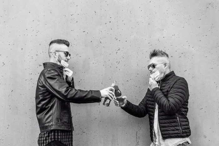 Framed Print : Guys friends toasting beer bottles with opened face masks - New normal lifestyle concept with people having fun Framed Print : Guys friends toasting beer bottles with opened face masks - New normal lifestyle concept with people having fun