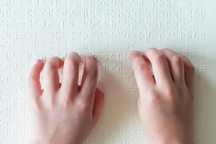 Framed Print : Hands of a blind child reading braille Framed Print : Hands of a blind child reading braille