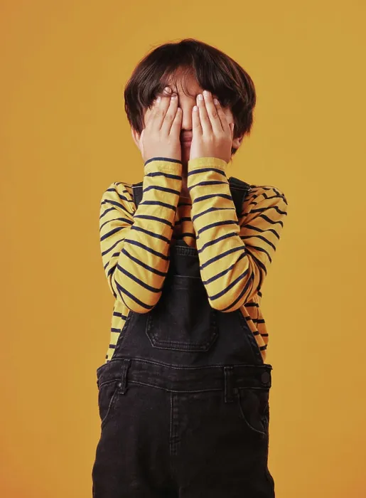 Framed Print : Hands, peekaboo or shy with child on yellow background Framed Print : Hands, peekaboo or shy with child on yellow background