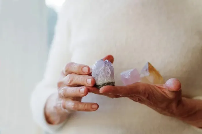 Framed Print : Hands of senior woman holding crystal stones Framed Print : Hands of senior woman holding crystal stones