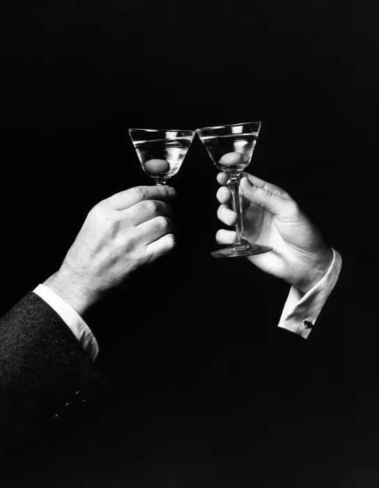 Framed Print : Two hands toasting with martini against black background Framed Print : Two hands toasting with martini against black background