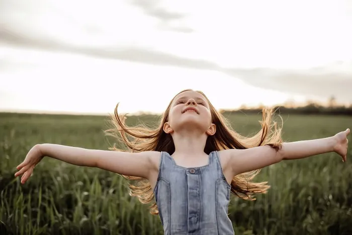 Framed Print : Happy 5 years old girl in a green wheat field with long hair at sunset