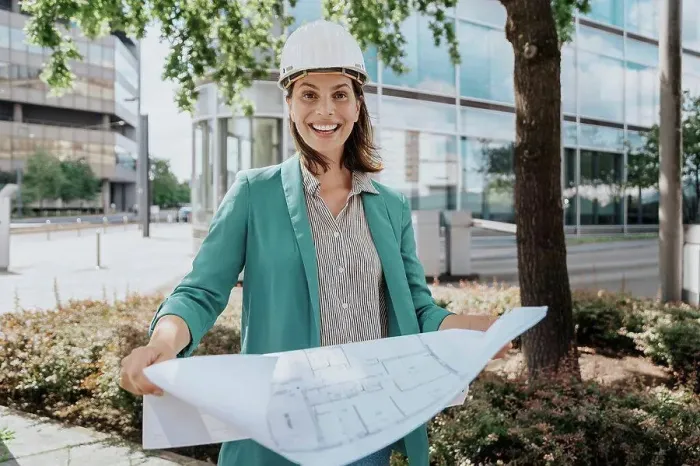 Framed Print : Happy architect wearing hardhat standing with construction plan Framed Print : Happy architect wearing hardhat standing with construction plan