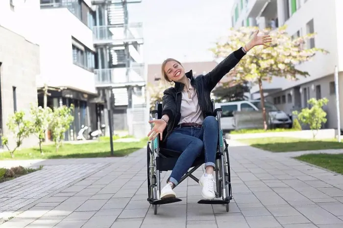 Framed Print : Happy disabled woman with arms outstretched sitting on wheelchair in residential area Framed Print : Happy disabled woman with arms outstretched sitting on wheelchair in residential area