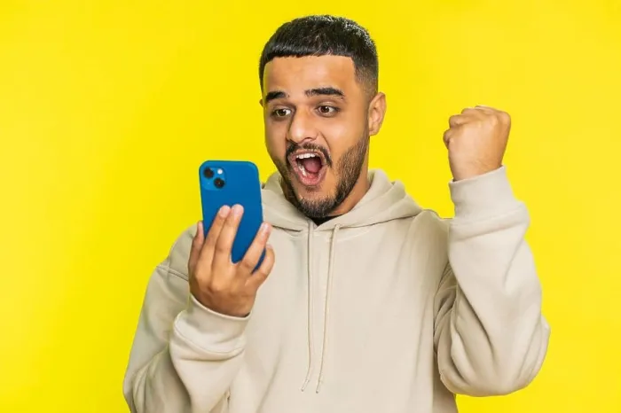 Framed Print : Happy excited winner man use smartphone celebrating success, winning play game, good lottery news Framed Print : Happy excited winner man use smartphone celebrating success, winning play game, good lottery news