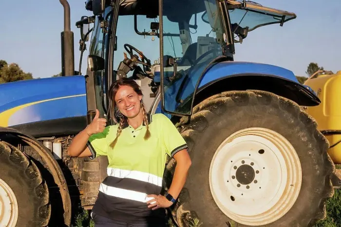 Framed Print : Happy female farmer gesturing thumbs up in front of tractor on sunny day