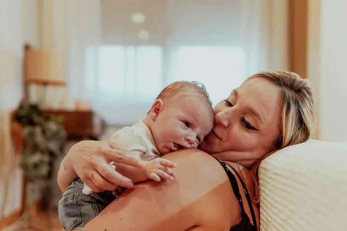 Framed Print : Happy mother looking at baby boy while sitting at home Framed Print : Happy mother looking at baby boy while sitting at home