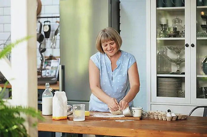 Framed Print : Happy senior woman housewife making kneading dough for pie while standing behind wooden table in kitchen with Framed Print : Happy senior woman housewife making kneading dough for pie while standing behind wooden table in kitchen with