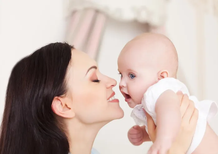 Framed Print : Happy smiling mother with six month old baby girl indoor Framed Print : Happy smiling mother with six month old baby girl indoor