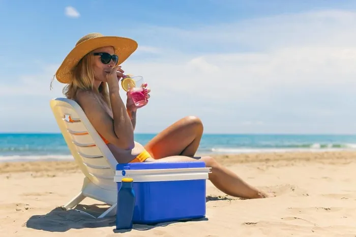Framed Print : Happy young european girl drinks a cocktail and rests in a sun lounger on the beach Framed Print : Happy young european girl drinks a cocktail and rests in a sun lounger on the beach