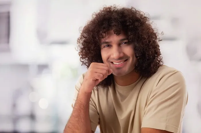Framed Print : A HAPPY YOUNG MAN WITH CURLY HAIR SMILING CHEERFULLY AT CAMERA Framed Print : A HAPPY YOUNG MAN WITH CURLY HAIR SMILING CHEERFULLY AT CAMERA