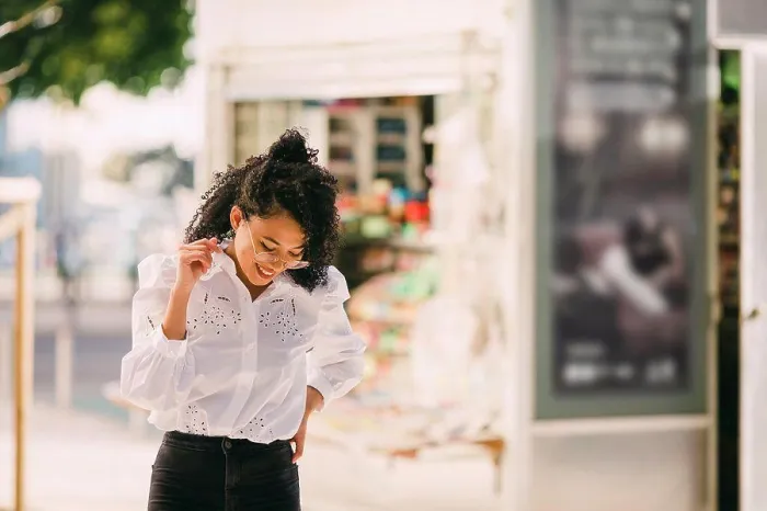 Framed Print : Happy young woman walking on urban sidewalk