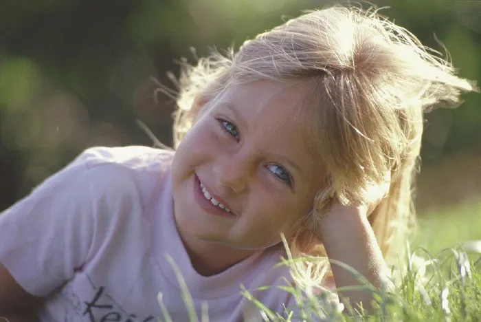 Framed Print : Hawaii closeup smiling girl lay in grass, blonde hair backlit Framed Print : Hawaii closeup smiling girl lay in grass, blonde hair backlit