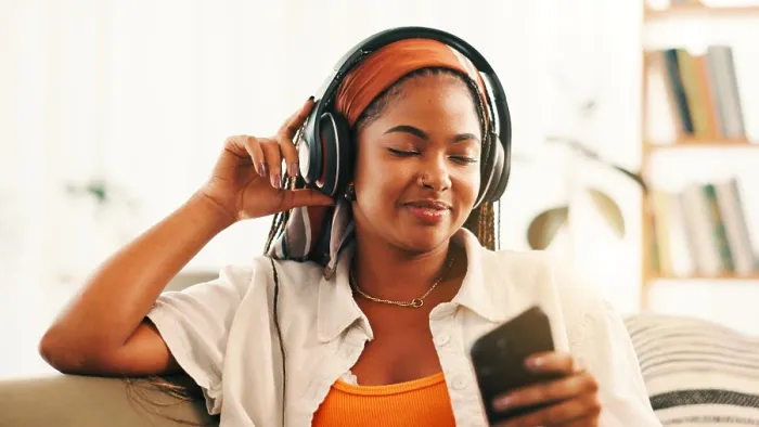 Framed Print : Headphones, happy woman and relax with mobile on sofa with podcast Framed Print : Headphones, happy woman and relax with mobile on sofa with podcast