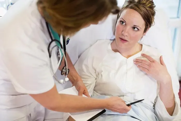 Framed Print : High angle view of female patient communicating with doctor in hospital ward