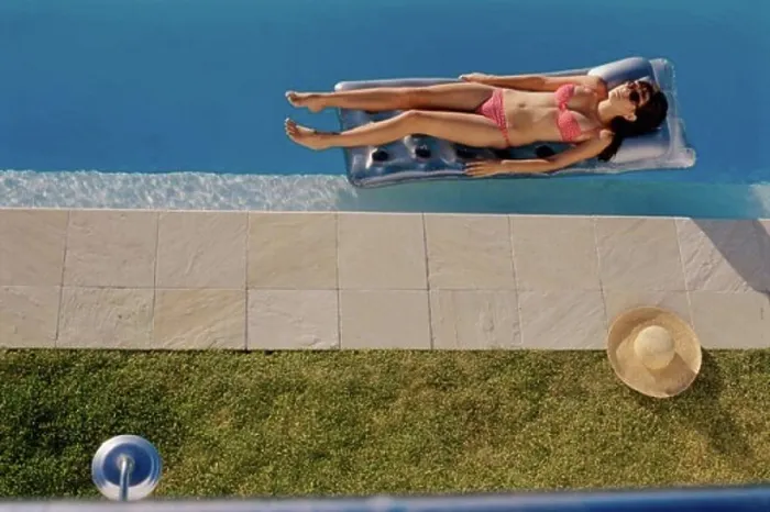 Framed Print : High angle view of a young woman lying on a pool raft Framed Print : High angle view of a young woman lying on a pool raft