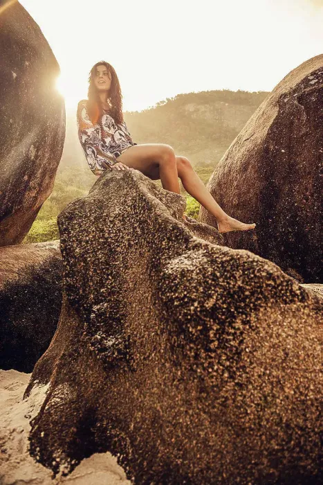 Framed Print : Hispanic woman sitting on boulder