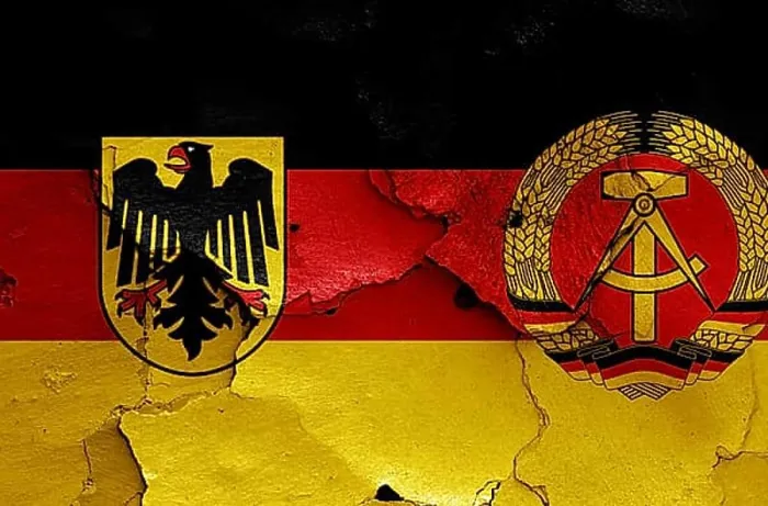 Framed Print : Historical flags of West Germany and East Germany painted on cracked wall Framed Print : Historical flags of West Germany and East Germany painted on cracked wall