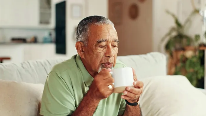 Framed Print : Home, coffee and senior man on sofa Framed Print : Home, coffee and senior man on sofa