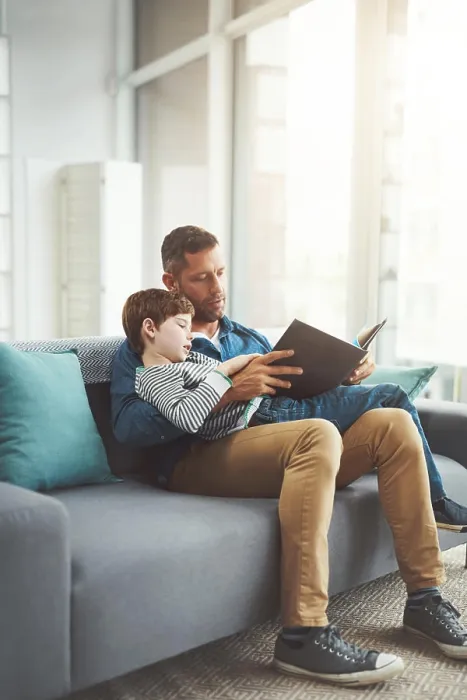 Framed Print : Home, reading book and dad with boy on sofa Framed Print : Home, reading book and dad with boy on sofa