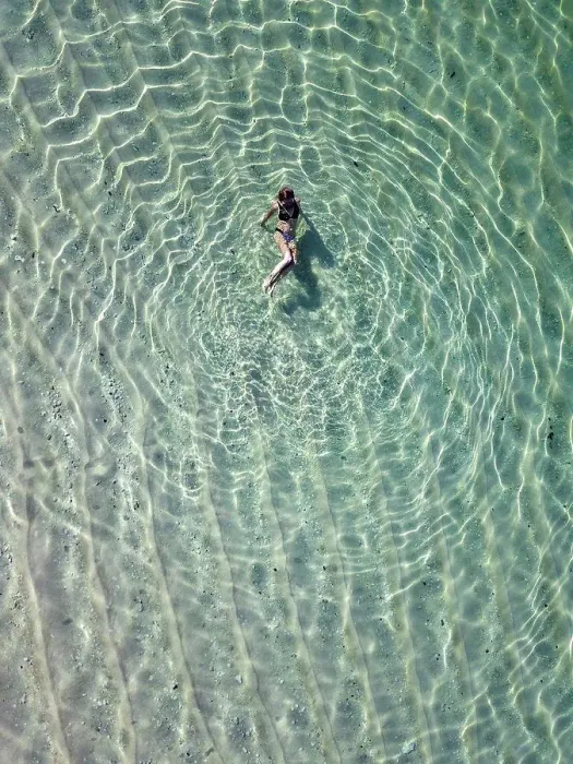 Framed Print : Indonesia, Bali, Melasti, Aerial view of Karma Kandara beach, woman in water Framed Print : Indonesia, Bali, Melasti, Aerial view of Karma Kandara beach, woman in water
