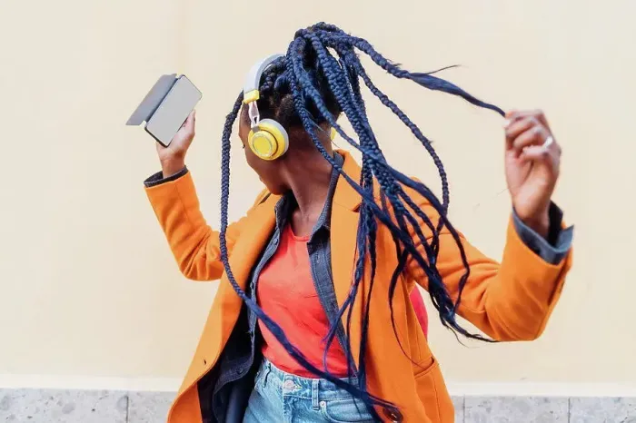 Framed Print : Italy, Milan, Woman with headphones and smart phone dancing outdoors Framed Print : Italy, Milan, Woman with headphones and smart phone dancing outdoors