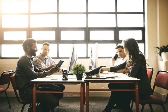 Framed Print : Just another day in the office. designers working in a modern office
