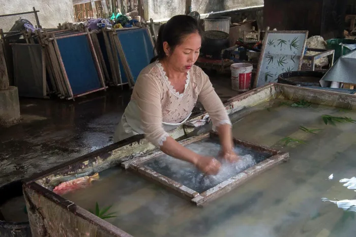 Framed Print : The jute paper production (fibers are being spread in water in a sift) in Ban Xang Khong Framed Print : The jute paper production (fibers are being spread in water in a sift) in Ban Xang Khong