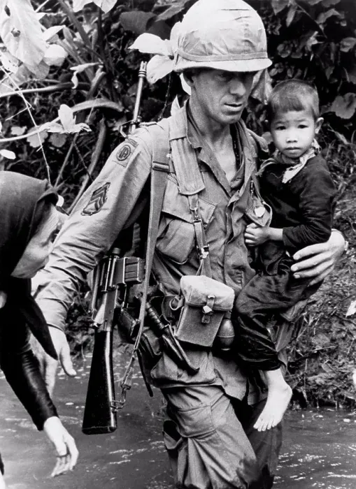 Framed Print : An Khe, Vietnam: 1967 A member of the 1st Calvary Division helps a Vietnamese woman and her child across a stream Framed Print : An Khe, Vietnam: 1967 A member of the 1st Calvary Division helps a Vietnamese woman and her child across a stream