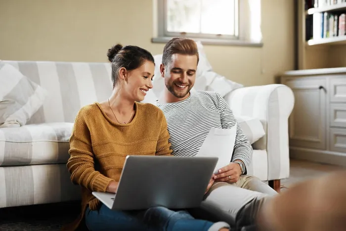 Framed Print : Laptop, planning and documents with couple in living room for investment portfolio