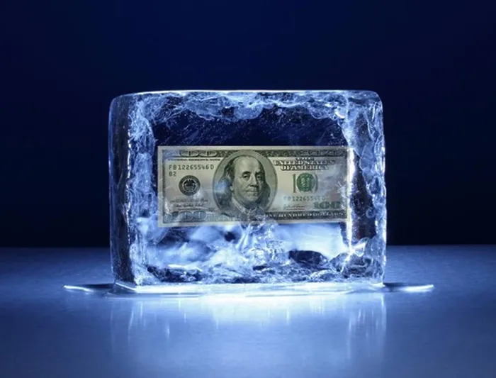 Framed Print : Large block of ice with one hundred dollar bill frozen inside Framed Print : Large block of ice with one hundred dollar bill frozen inside