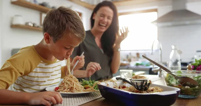 Framed Print : Laugh, food and pasta with family at kitchen table for nutrition