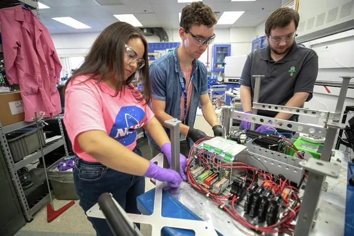 Framed Print : From left, Kennedy Space Center interns Brianna Sandoval and Patrick Follis