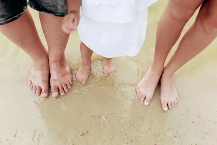 Framed Print : legs dad, mom, daughters. The family legs with little daughter on the beach Framed Print : legs dad, mom, daughters. The family legs with little daughter on the beach
