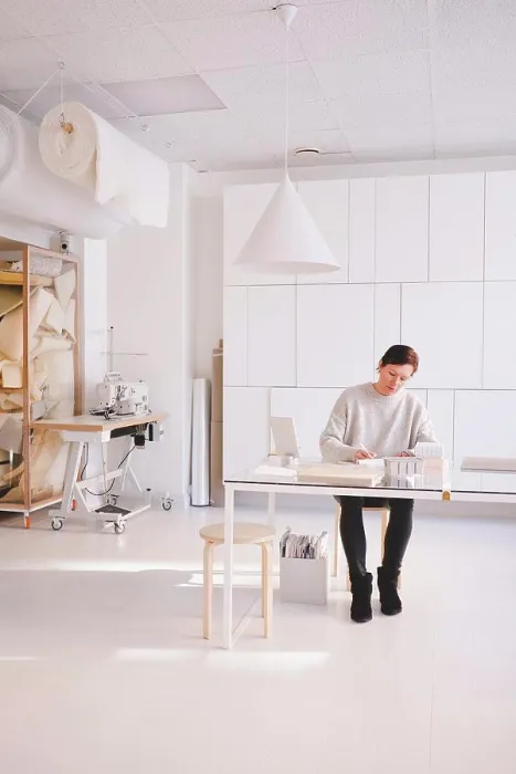 Framed Print : Full length of mature female design professional is writing in note pad at desk in workshop Framed Print : Full length of mature female design professional is writing in note pad at desk in workshop